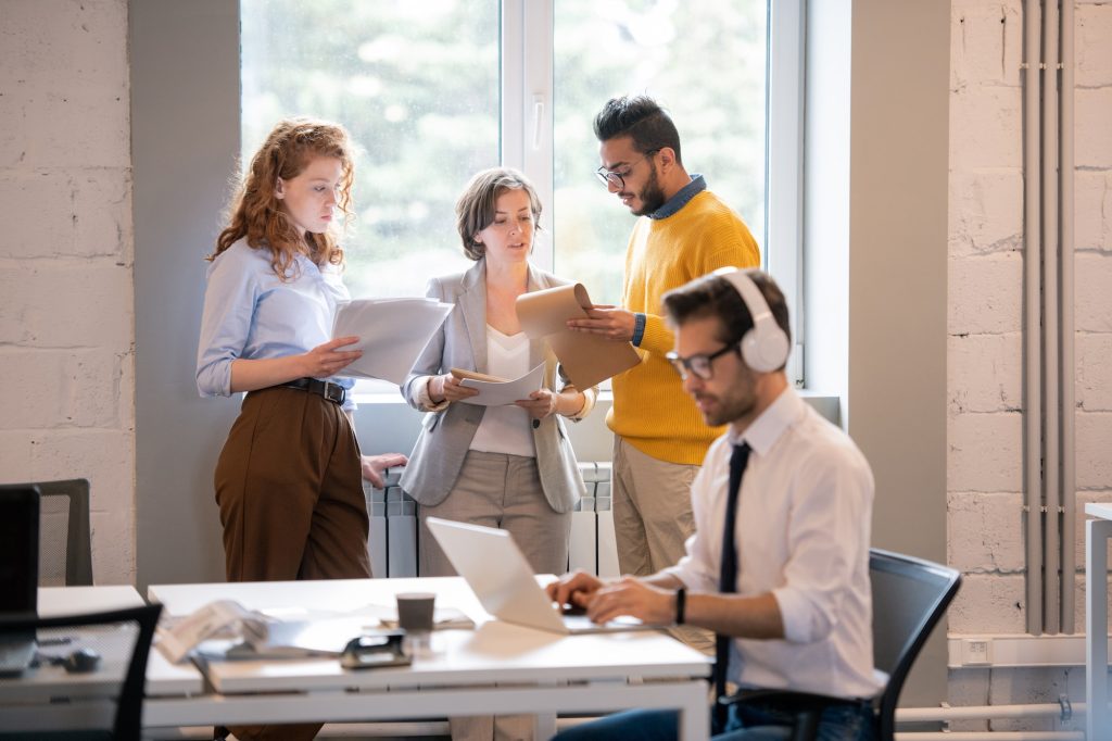 Content pensive young multi-ethnic colleagues