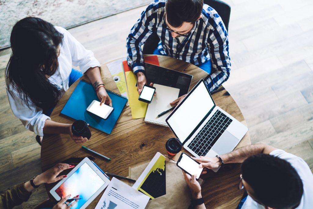 Group of freelancers browsing advertising publication