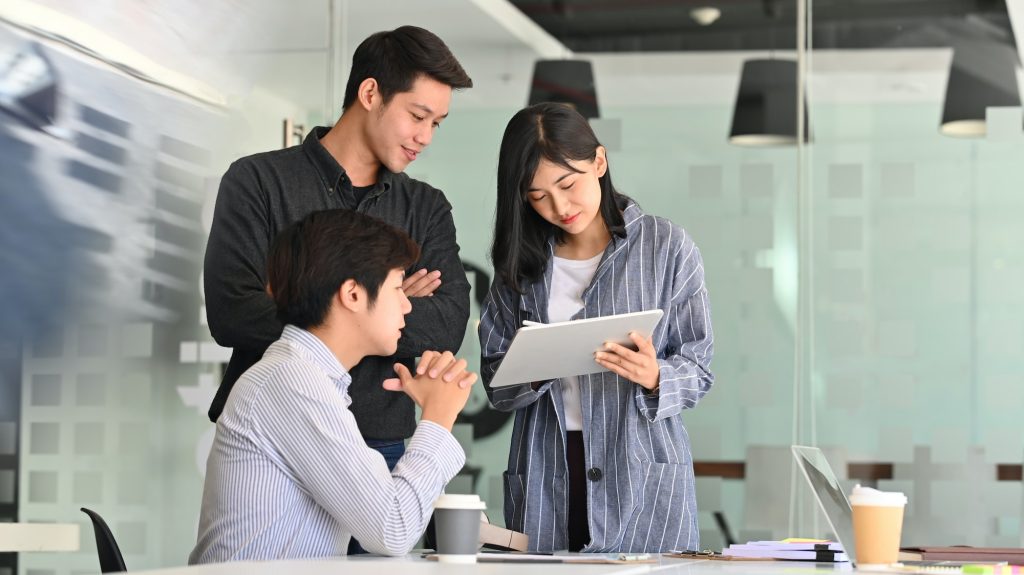 Team startup business discussion with tablet computer.